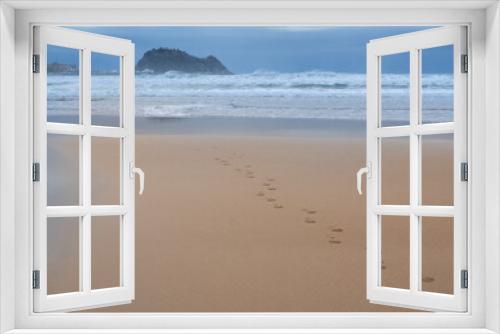 Fototapeta Naklejka Na Ścianę Okno 3D - Footprints in the sand on the beach of Zarautz with Getaria in the background, Euskadi