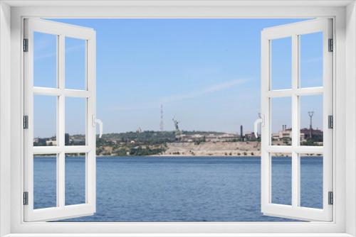 Fototapeta Naklejka Na Ścianę Okno 3D - The Volga River. The ship is approaching the city of Volgograd (formerly Stalingrad). In the distance, on the top of Mamayev Kurgan, a monument to Mother Motherland is visible.