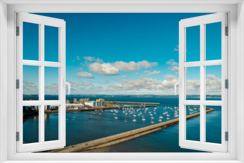 Fototapeta Naklejka Na Ścianę Okno 3D - Iconic marina, located along the east coast of Scotland, presents a stunning view of the sea. Taking an aerial view of the marina, the image displays a stunning image of the marina yachts and boats.