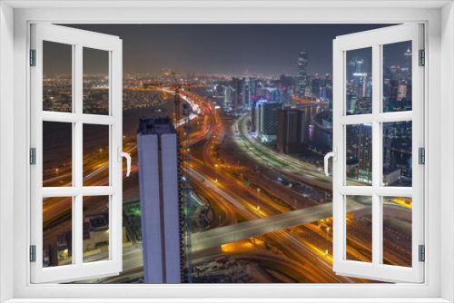 Fototapeta Naklejka Na Ścianę Okno 3D - Skyline with modern architecture of Dubai business bay towers night timelapse. Aerial view