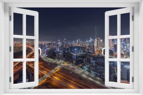 Fototapeta Naklejka Na Ścianę Okno 3D - Panoramic skyline of Dubai with business bay and downtown district night timelapse.