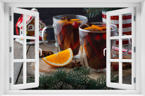Fototapeta Naklejka Na Ścianę Okno 3D - Christmas mulled red wine with spices and oranges on a wooden rustic table. Traditional hot drink at Christmas