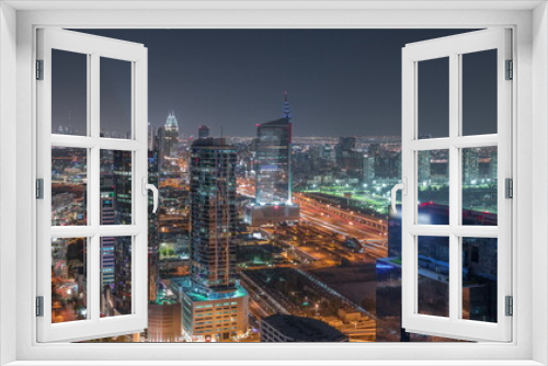Fototapeta Naklejka Na Ścianę Okno 3D - Aerial view of media city and al barsha heights district area night timelapse from Dubai marina.