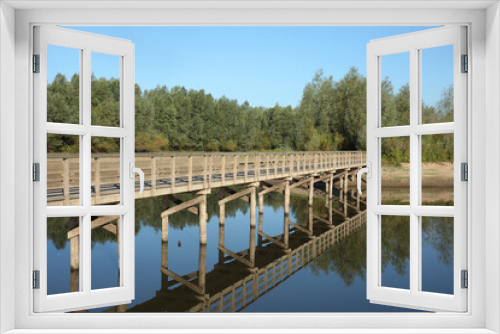 Fototapeta Naklejka Na Ścianę Okno 3D - A wooden bridge in a side channel of the river IJssel at Deventer, the Netherlands
