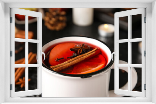 Fototapeta Naklejka Na Ścianę Okno 3D - Cup of tasty fruit tea with cinnamon on black background, closeup
