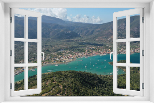 Fototapeta Naklejka Na Ścianę Okno 3D - Aerial drone photo of fjord shaped port of Nydri a calm sea safe anchorage for sail boats and yachts famous for trips to Meganisi, Skorpios and other Ionian islands, Lefkada island, Greece