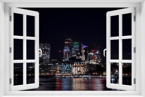 Fototapeta Naklejka Na Ścianę Okno 3D - Panoramic view of the London financial district with many skyscrapers in the center of London at night. 