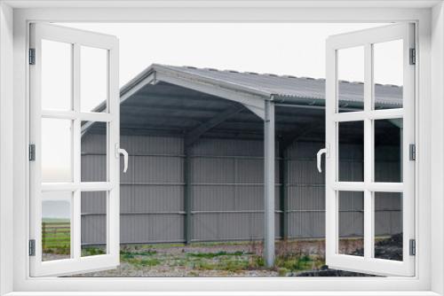 Fototapeta Naklejka Na Ścianę Okno 3D - large empty corrugated barn with low cloud background, Wiltshire UK