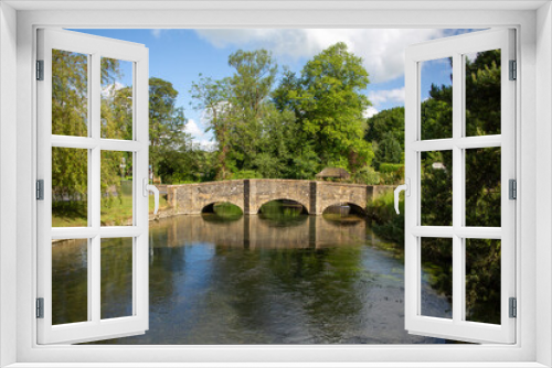 Fototapeta Naklejka Na Ścianę Okno 3D - Beautiful small bridge over calm water and green trees in summer at Arlington, UK