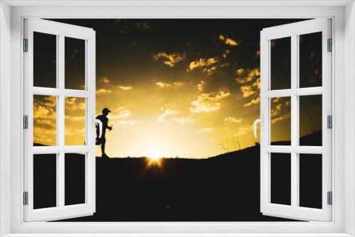 Fototapeta Naklejka Na Ścianę Okno 3D - Silhouette of a man running freely in the mountains.