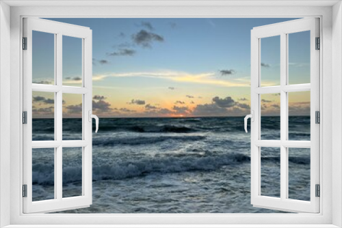 Fototapeta Naklejka Na Ścianę Okno 3D - Sunrise over the sea and beach with beautiful landscape in Riviera Maya, Mexico. Sun above the water in early morning over the Caribbean sea with gentle waves hitting the sand.