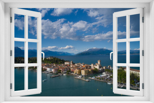 Fototapeta Naklejka Na Ścianę Okno 3D - Sirmione, Lake Garda, Italy. Aerial view of the island of Sirmione. Castle on the water in Italy. Panorama of Lake Garda. Peninsula on a mountain lake in the background of the alps.