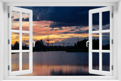 Fototapeta Naklejka Na Ścianę Okno 3D - Sunset in the city by the pond