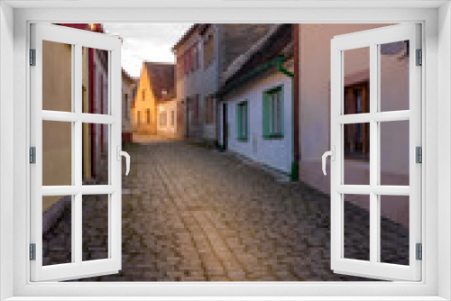 Fototapeta Naklejka Na Ścianę Okno 3D - Picturesque streets and decorative houses in Telc. The picturesque castle and the historic center with the decorative facades of the houses belong to the UNESCO World Heritage Site, Czech Republic.