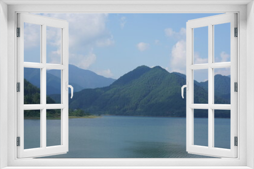 Fototapeta Naklejka Na Ścianę Okno 3D - The beautiful lake landscapes surrounded by the green mountains in the countryside of the China