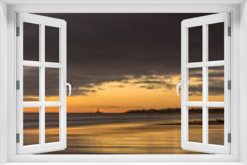 Fototapeta Naklejka Na Ścianę Okno 3D - Sunrise to start the day at Blyth beach in Northumberland, with St Mary's Lighthouse in the distance