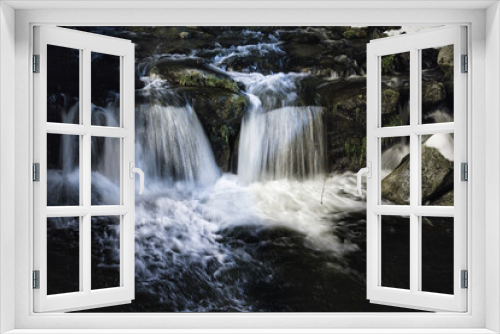 Fototapeta Naklejka Na Ścianę Okno 3D - In the heart of the mountains in winter, at night, a river, the water falling on the foamy rocks and the snow on each side