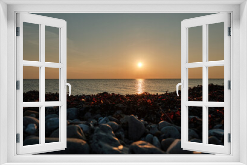 Fototapeta Naklejka Na Ścianę Okno 3D - Romantic sunset over baltic sea at a pebble beach