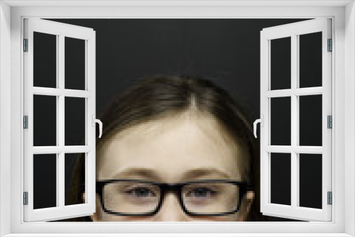 Smart young girl stood infront of a blackboard