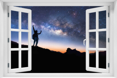 Fototapeta Naklejka Na Ścianę Okno 3D - Landscape with Milky Way. Night sky with stars and silhouette of a standing happy man on the mountain, Success or winner, leader concept. High iso with Noise.