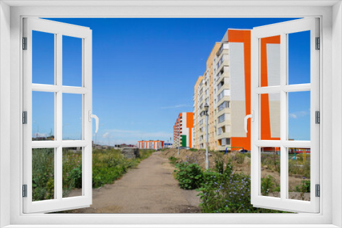 Fototapeta Naklejka Na Ścianę Okno 3D - Modern apartment buildings. kazakhstan (Ust-Kamenogorsk). New residential area. Contemporary architecture. Blue Sky and Green Grass. New Houses