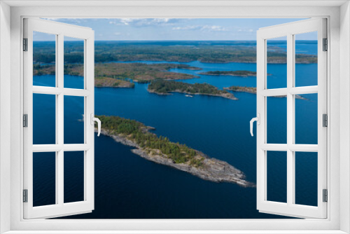 Fototapeta Naklejka Na Ścianę Okno 3D - Aerial photography on Ladoga skerries. Ladoga Lake in Karelia in hot summer. Rocky wild islands in the middle of the lake. Russian nature