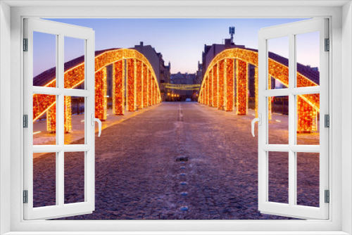 Fototapeta Naklejka Na Ścianę Okno 3D - Poznan. The Bishop Jordan Bridge in the early morning festive illumination.