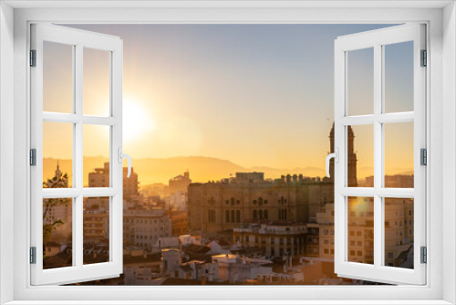 Fototapeta Naklejka Na Ścianę Okno 3D - Sunset from the walls of the Alcazaba of the city of Malaga and in the background the Cathedral of the Incarnation of Malaga, Andalusia. Spain. Medieval fortress in arabic style