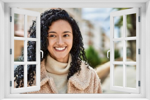 Young hispanic woman smiling confident at street