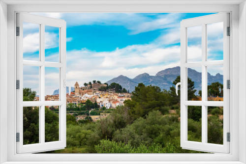 Fototapeta Naklejka Na Ścianę Okno 3D - The ancient Spanish city of Polop in the province of Alicante, Costa Blanca against the backdrop of beautiful landscapes, mountains and blue sky with clouds. Travel and family vacation concept.