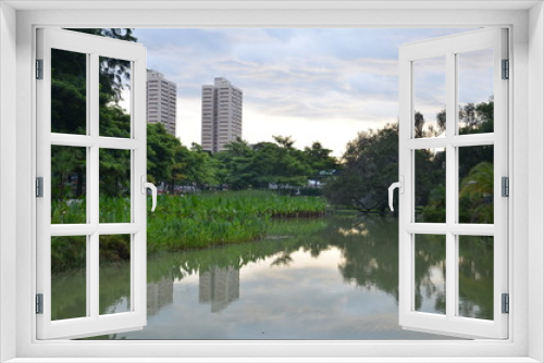 Fototapeta Naklejka Na Ścianę Okno 3D - Two high rise buildings in Singapore as seen from a local park.