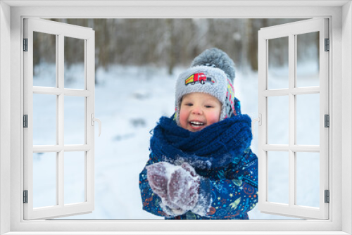 little boy walk winter in the snowy forest