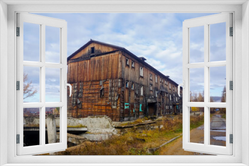 Fototapeta Naklejka Na Ścianę Okno 3D - Old abandoned three-story house in the north of the Amur region