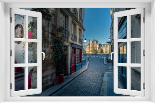Fototapeta Naklejka Na Ścianę Okno 3D - Paris, France - April 3, 2021: Small cosy street with City Hall in background in Paris