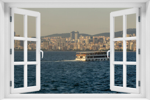 Fototapeta Naklejka Na Ścianę Okno 3D - City ferry going from the Adara Islands against the background of the evening Stanbul, Turkey, Istanbul, Buyukada