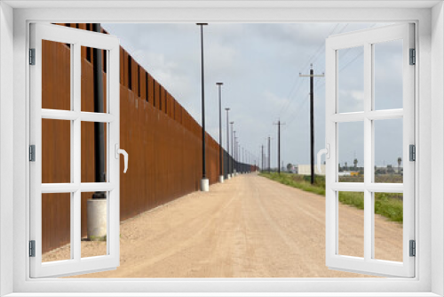 Fototapeta Naklejka Na Ścianę Okno 3D - USA-Mexico border in Texas, United States. The newly built border wall.
Walls and security roads.