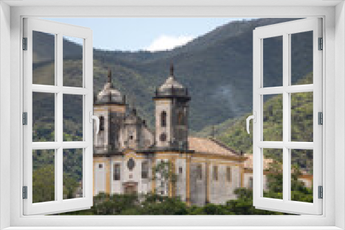 Fototapeta Naklejka Na Ścianę Okno 3D - View of the Church of São Francisco de Paula, with mountains in the background. Historic city of Ouro Preto, Minas Gerais. Portuguese colonial village, capital of Brazil in the Golden Age.