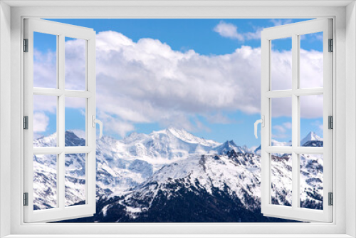 Fototapeta Naklejka Na Ścianę Okno 3D - Winter alps landscape, top of the snowy mountains with cloudscape, blue sky. Snowy mountain peaks in Swiss alps, Wallis.