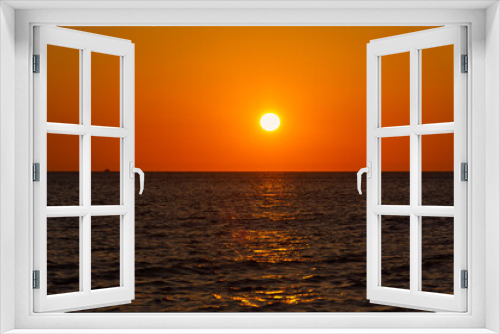 Fototapeta Naklejka Na Ścianę Okno 3D - Sunset sea boat. Romantic summer landscape with a round orange sun. Minimalism in nature. The concept of summer, recreation, tourism, travel on a sea ship. tropical sunset or sunrise over the ocean