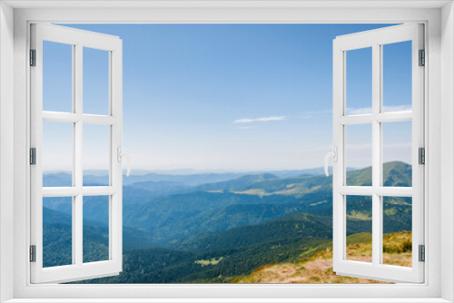 summer landscape, green peaks of mountain hills against the background of the morning blue sky. High quality photo