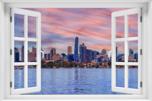 Fototapeta Naklejka Na Ścianę Okno 3D - Sydney Harbour Australia at Sunset with the turquoise colours of the bay and high rise offices of the City in the background