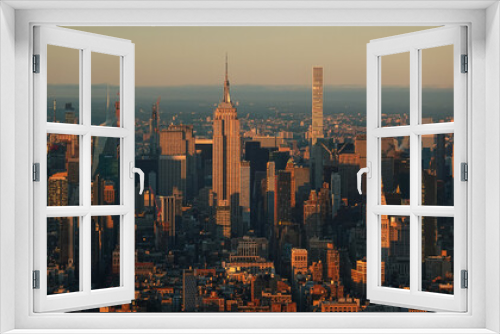 Fototapeta Naklejka Na Ścianę Okno 3D - Sunset in New York, view from above. Amazing sun light over Manhattan and Hudson river during a sunset, images taken from the highest building in the city. Impressive architecture. Landmark of America