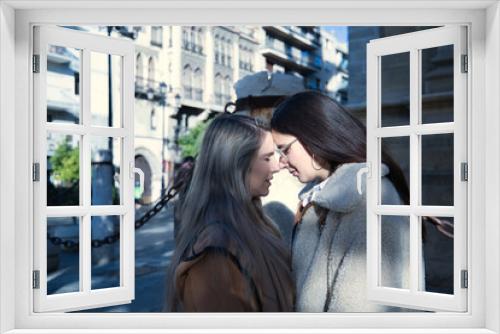 Real couple of young women putting their foreheads together with eyes closed in loving attitude. Concept lgtbiq+, lesbians, in love, inclusion.