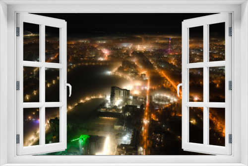 Fototapeta Naklejka Na Ścianę Okno 3D - Aerial view of high rise apartment buildings and bright illuminated streets in Ivano-Frankivsk city, Ukraine residential area at night. Dark urban landscape