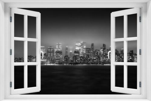 Fototapeta Naklejka Na Ścianę Okno 3D - View from Liberty State Park in New Jersey of the New York City Cityscape at Night on a Foggy Day in Black and White