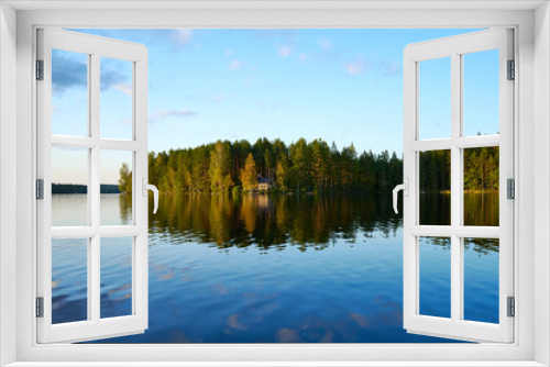 Fototapeta Naklejka Na Ścianę Okno 3D - Wunderschöner Blick auf Stukas Ferienhäuser vom See aus in Schweden mit Spiegelungen im Wasser vom Boot aus Im Schwedenurlaub