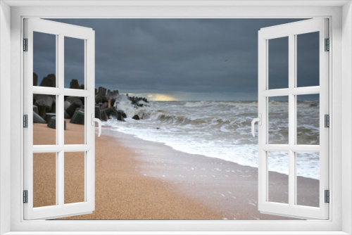 Fototapeta Naklejka Na Ścianę Okno 3D - Stormy sea, heavy clouds, sandy shore and breakwater.