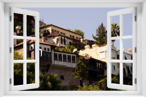 Fototapeta Naklejka Na Ścianę Okno 3D - Landscapes of Turkish resort town. Old houses with palm trees are located on hillside. Holidays in Turkey with copy space.