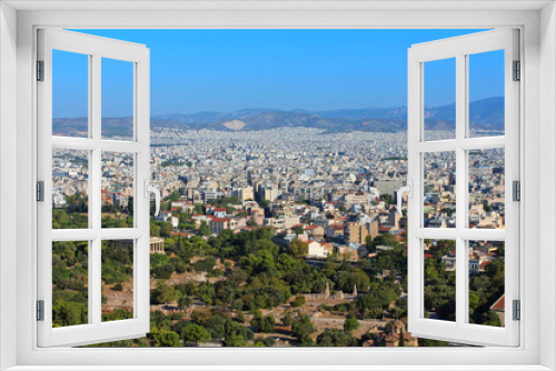 View of ancient temple of Hephaestus in Agora and city of Athens in Greece