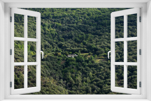 Maison blanche, corps de ferme, perdu dans l'immensité de la forêt au milieu d'une montagne boisée et sauvage. Cévennes France.